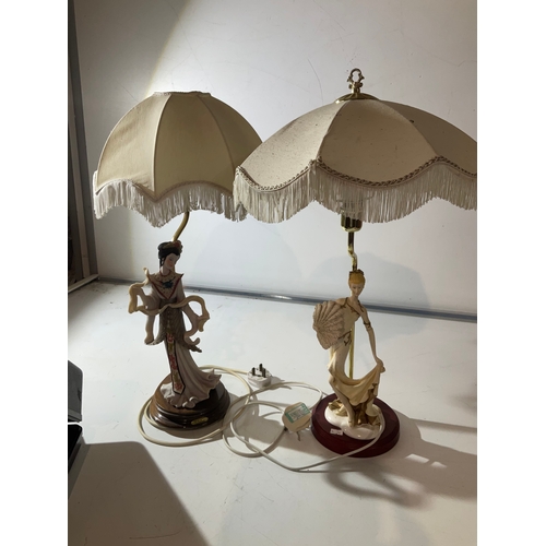 214B - 2 table lamps with porcelain figures one is oriental both with cream lamp shades