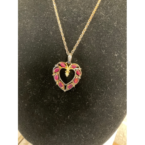 215A - Gold coloured stamped 925 4.58g Silver necklace with red stones in heart shaped pendant