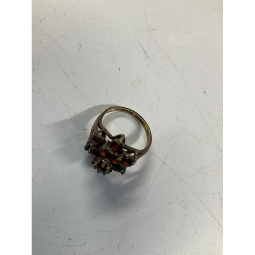 83A - 9ct gold dress ring with a floral cluster of red gem stones - 3grams of 9ct -  size I