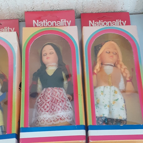 8 - Quantity of full set of 12 nationality costume dolls with sleeping eyes. Dolls never been out of box... 