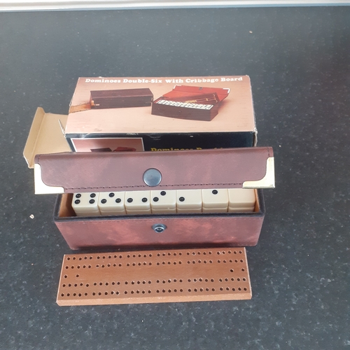 9 - A set of double 6 dominoes and cribbage board in original packaging. Outer box shows a little wear b... 