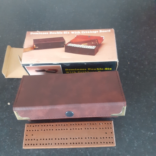 9 - A set of double 6 dominoes and cribbage board in original packaging. Outer box shows a little wear b... 