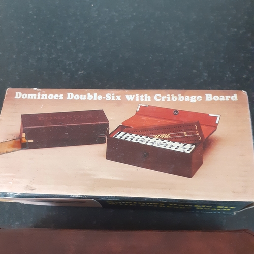 9 - A set of double 6 dominoes and cribbage board in original packaging. Outer box shows a little wear b... 