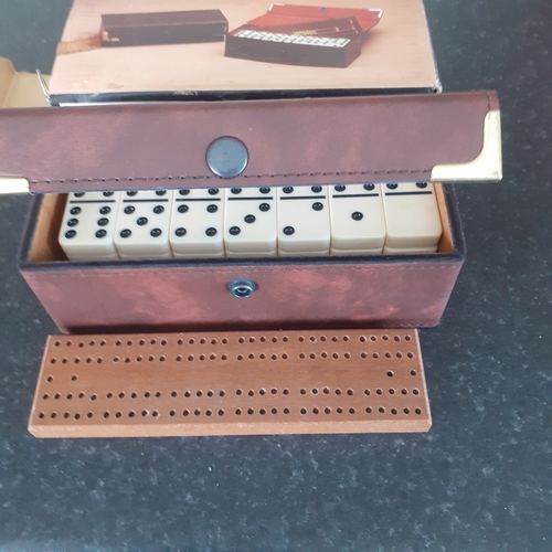 9 - A set of double 6 dominoes and cribbage board in original packaging. Outer box shows a little wear b... 