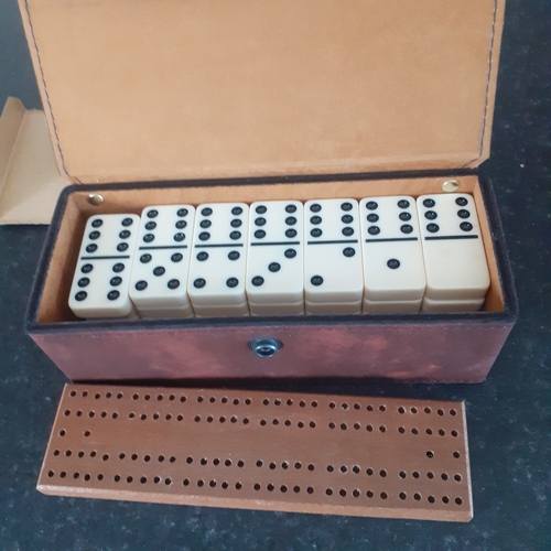 9 - A set of double 6 dominoes and cribbage board in original packaging. Outer box shows a little wear b... 