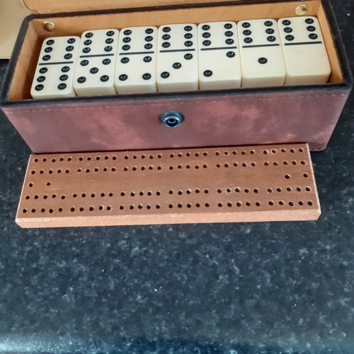 9 - A set of double 6 dominoes and cribbage board in original packaging. Outer box shows a little wear b... 