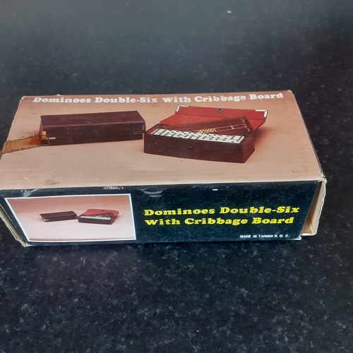 9 - A set of double 6 dominoes and cribbage board in original packaging. Outer box shows a little wear b... 