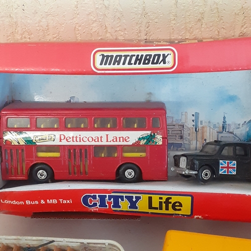 18 - A matchbox diecast city life bus, with a selection of other buses and trams. Boxed item has never be... 