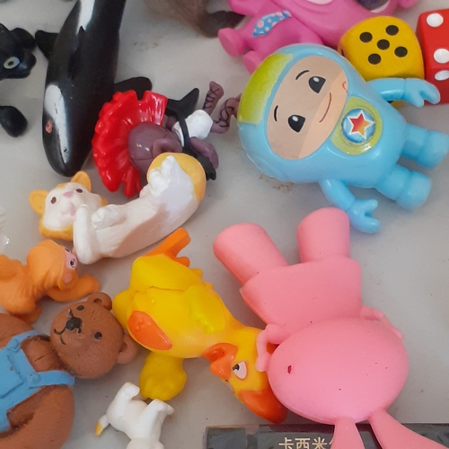 19 - Large quantity of small toys. Includes Smurf, Batman, spacemen, small animals, some wind up toys and... 