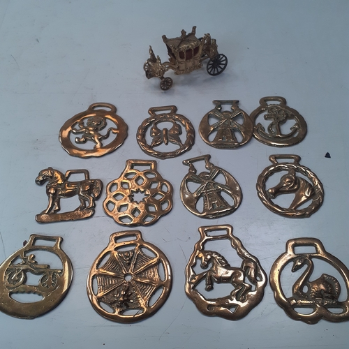 20 - Quantity of horse brasses with a small brass carraige. Unusual more rare brass depicting spiders web... 