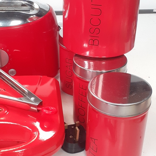 42 - Red kitchenware. Grill, toaster, utensils and cutlery, tea, coffee, sugar, biscuit cannisters,  crue... 