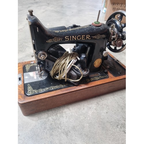 121 - Vintage singer sewing machine in case with key