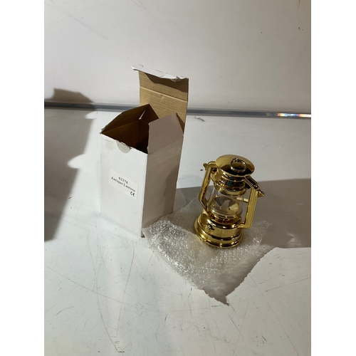 139 - Brass coloured light up lantern. Approx 16 cm in height.