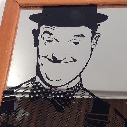 28 - Laurel and Hardy mirror. Measures approx 12 x 8 