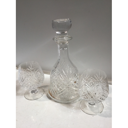 8 - Cut glass decanter and a pair of brandy glasses