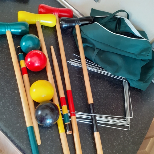 19 - Wooden croquet set. Colourfully painted in good condition. With carry bag and instructions