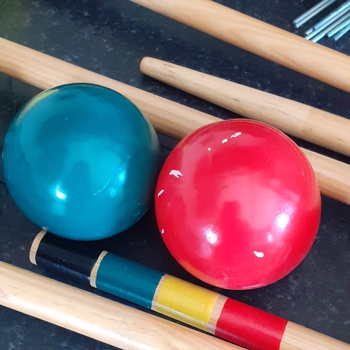 19 - Wooden croquet set. Colourfully painted in good condition. With carry bag and instructions