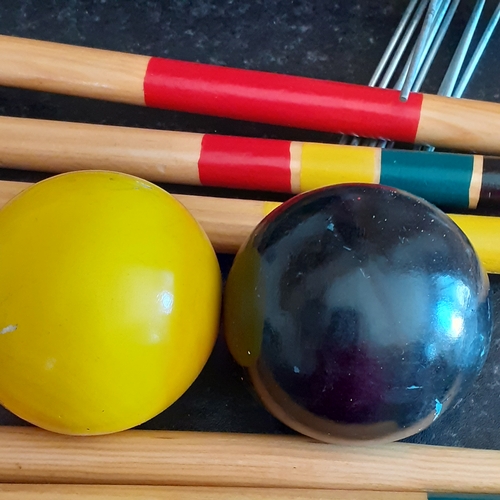 19 - Wooden croquet set. Colourfully painted in good condition. With carry bag and instructions