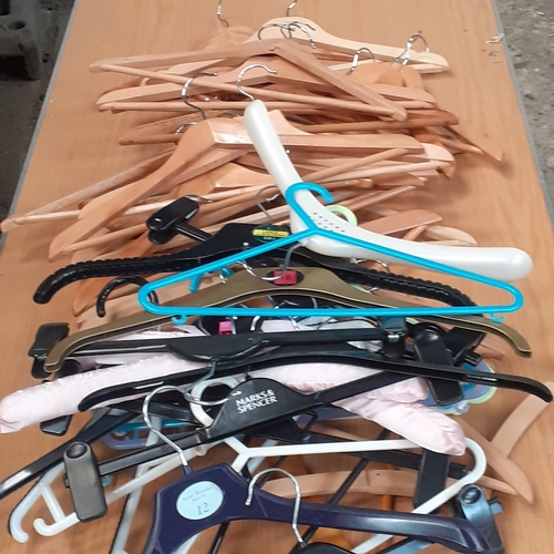 27 - A large number of mixed coathangers. Different styles. Lots of wooden trouser/suit hangers which are... 
