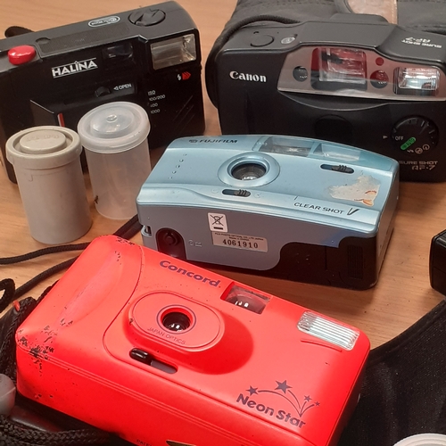 10 - A quantity of film cameras with 12 film pods, x10 containing films, 2 empty. Includes Canon, Hanimex... 