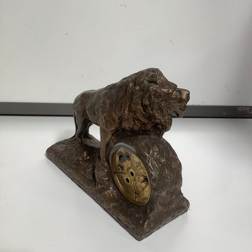 63 - Lion on rock mantle clock - bronze looking