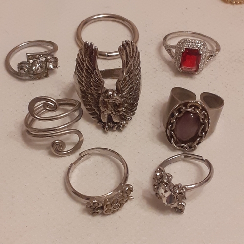 22 - A collection of silver coloured rings with some gothic style designs and some with various stones