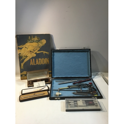 298 - Case of compasses & pens as well Parker & other pens and a vintage Aladdin book