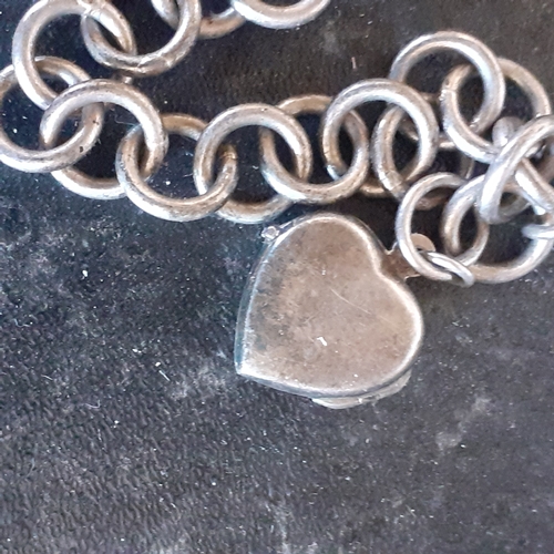 93 - Sterling silver chain link style bracelet with heart shaped pendant. Weight approx 20.3g