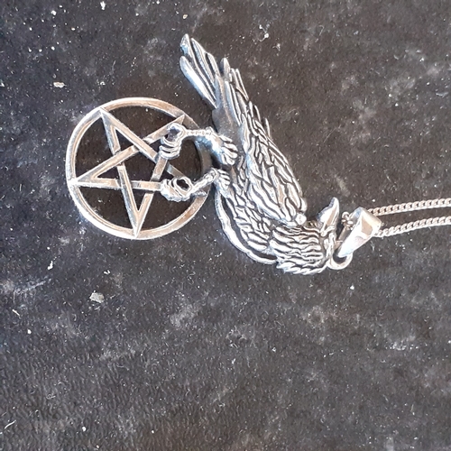 95 - Sterling silver pentagram lookout raven pendant on a silver chain. Weight approx 6g