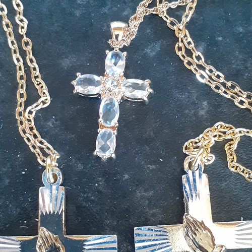 96 - A selection of 4 crucifixes on chains. 2 show healing hands, one has faux pearl design and the other... 