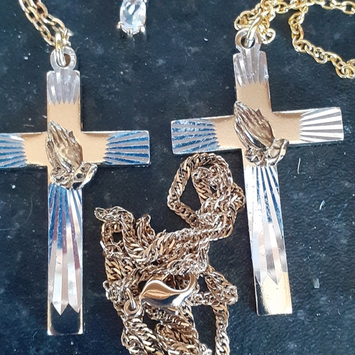 96 - A selection of 4 crucifixes on chains. 2 show healing hands, one has faux pearl design and the other... 