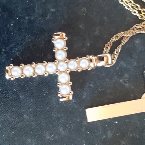 96 - A selection of 4 crucifixes on chains. 2 show healing hands, one has faux pearl design and the other... 