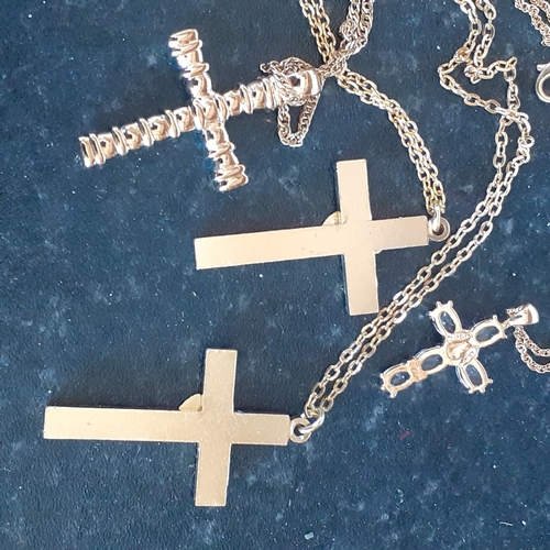 96 - A selection of 4 crucifixes on chains. 2 show healing hands, one has faux pearl design and the other... 