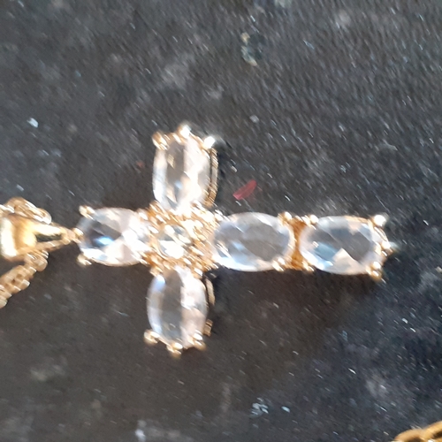 96 - A selection of 4 crucifixes on chains. 2 show healing hands, one has faux pearl design and the other... 