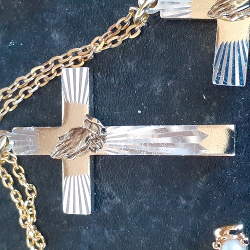 96 - A selection of 4 crucifixes on chains. 2 show healing hands, one has faux pearl design and the other... 