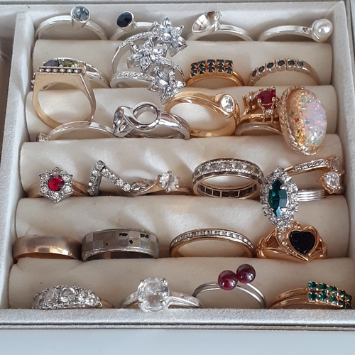 23 - White wooden jewellery box containing a quantity of rings. Varying colours and stones. Some very eye... 