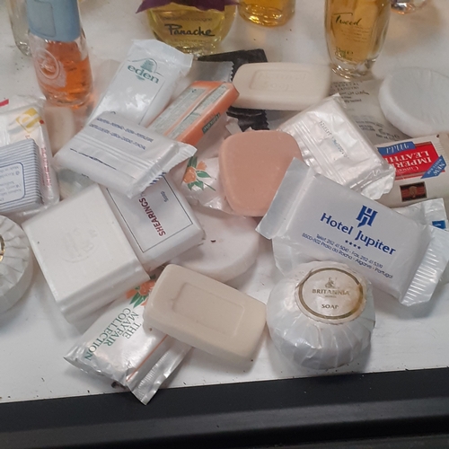 14 - More than 20 vintage bottles of perfumes and eau de toilette.  Some hotel/travel soaps. Most bottles... 