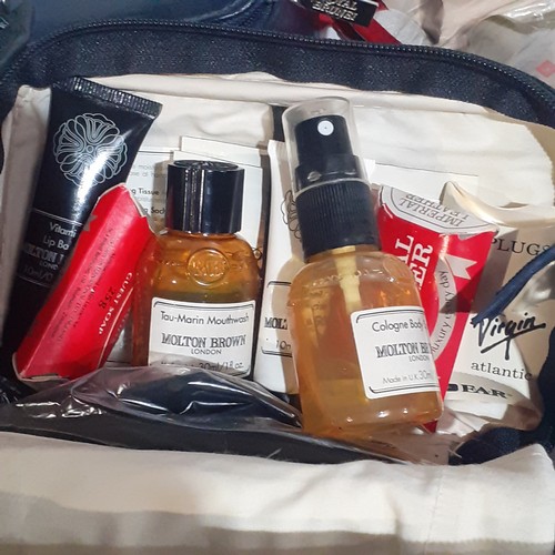 15 - A collection of airline/cruise issue travel bags. Some vintage have the liquid contents evaporated. ... 