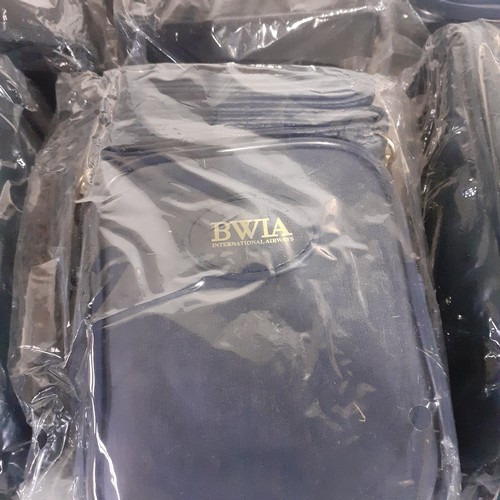 26 - A collection of 6, new in wrapper, never opened, airline issue travel bags. BWIA airlines and others