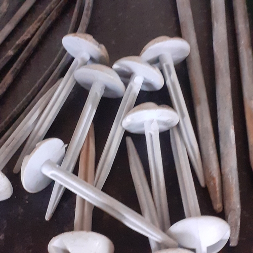 33 - Tent peg lot. Quantity of different size pegs with mallet covering anchoring needs for mostly style ... 