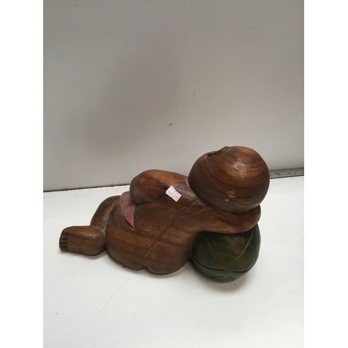 57 - Asian carved wooden sleeping baby Buddha - 13” long