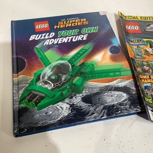 329 - Lego magazine and superheroes build your own adventure manual. Magazine includes limited edition din... 