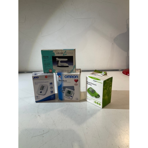 140 - Mixed boxed lot including travel iron, and 3 blood pressure monitors