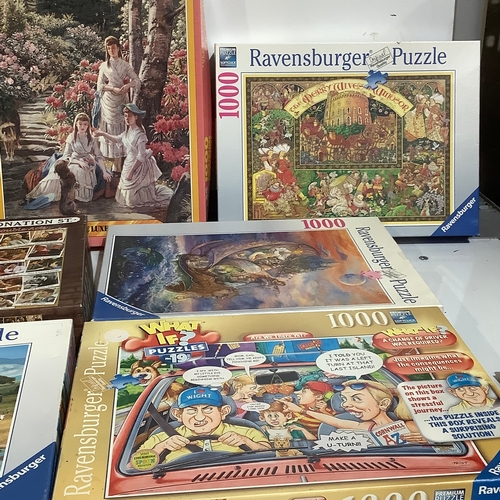 355 - Quantity of jigsaw of puzzles, including mostly Ravensburger, a falcon, and 1000 piece national puzz... 