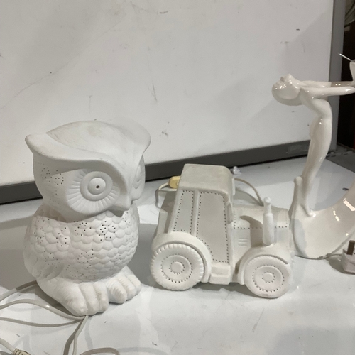 356 - White pottery pieces. Owl lamp, and nude lady lamp. Tractor shape candle surround.