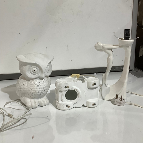 356 - White pottery pieces. Owl lamp, and nude lady lamp. Tractor shape candle surround.