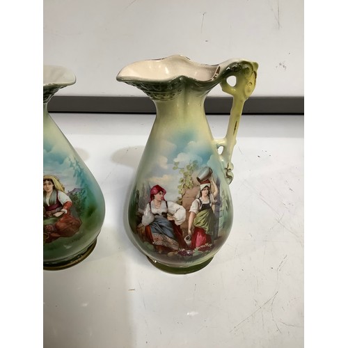 76 - Pair of painted matching jugs