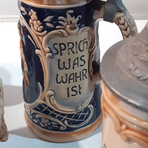 269 - 5 x West German lidded beer steins. Ceramic made with metal lids, these have great features and no d... 