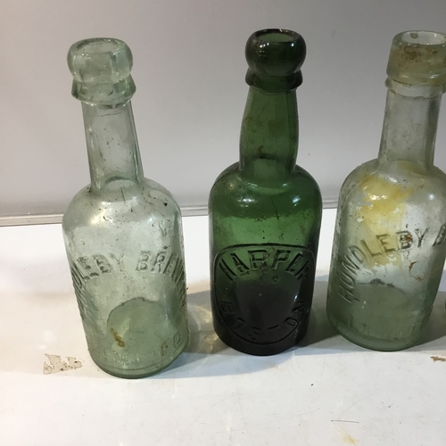 234 - Set of 4 vintage glass bottles inc Harper Boston, Horncastle & Hundelby