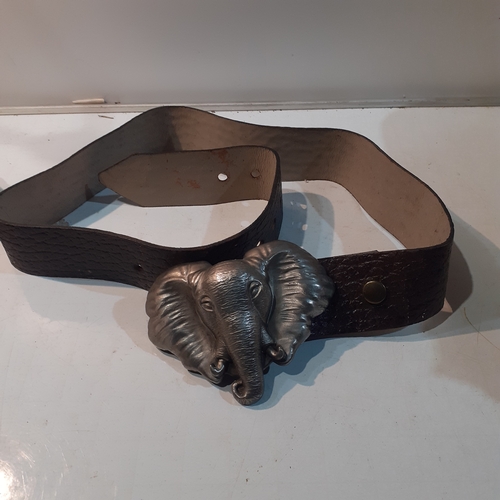 2 - Large belt with an elephant design metal buckle. Has serial number stamped on back of buckle 2077. E... 